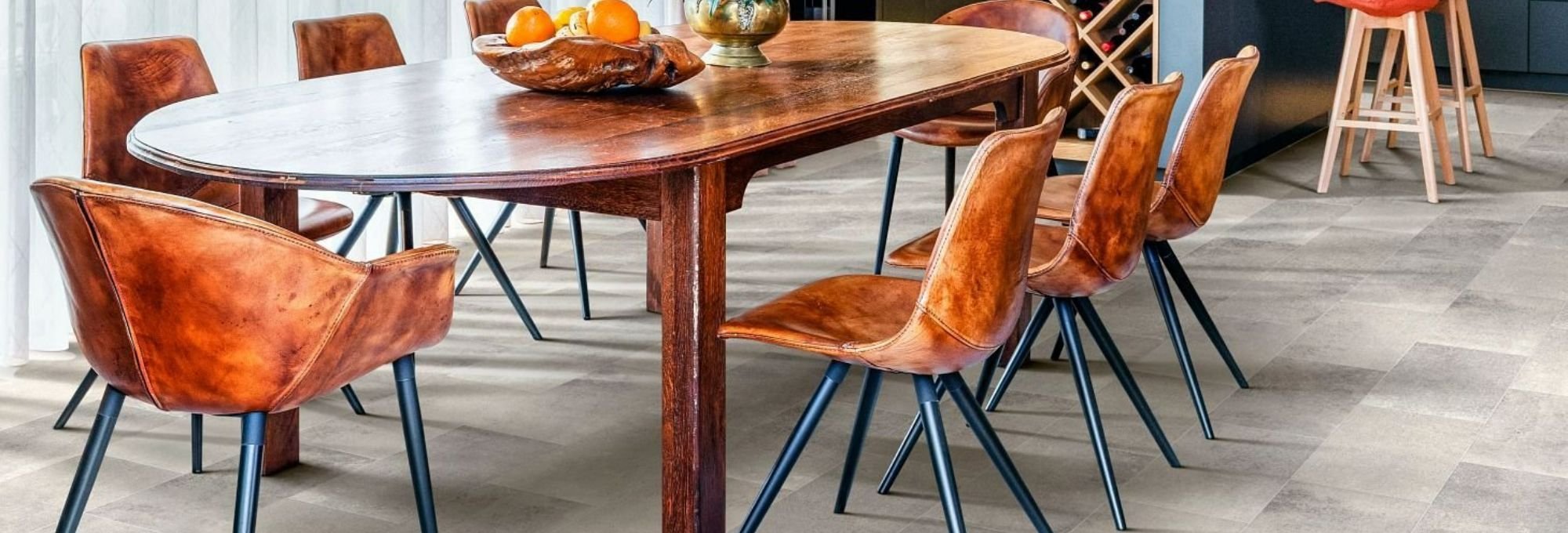 brown dining table and brown chairs on light gray laminate floor from Carter Carpets & Vinyl in Temperance, MI